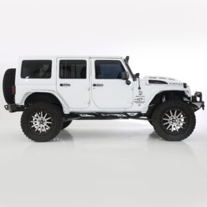 White lifted Jeep Wrangler Rubicon Unlimited with large off-road tires and rock rails